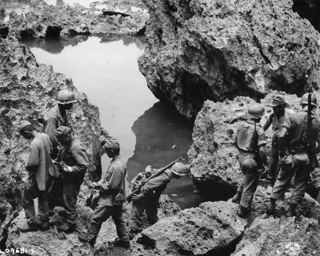 7th Infantry Division troops conduct mop-up operations on Okinawa following the end of major hostilities.