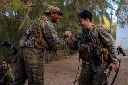 U.S. Army Soldiers with 2nd Infantry Brigade Combat Team, 25th Infantry Division, celebrate a combat engagement victory over blue forces at Kahuku Training Area, Hawaii, Nov. 9, 2023. The Joint Pacific Multinational Readiness Center (JPMRC) is the...