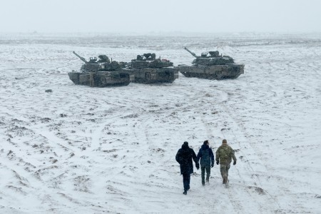 A U.S. Army Soldier with 3rd Battalion, 67th Armored Regiment, 2nd Armored Brigade Combat Team, 3rd Infantry Division, and members of the Lithuanian Parliament take a close-up look at M1A2 Abrams tanks during a tour of Camp Herkus, Lithuania, Jan....