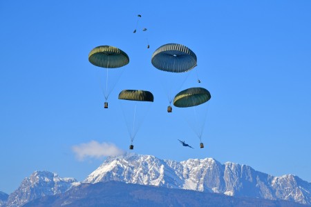 U.S. Army paratroopers assigned to 1st Battalion, 503rd Parachute Infantry Regiment, 173rd Airborne Brigade, release heavy drop packages with a U.S. Air Force 86th Air Wing C-130 Hercules aircraft onto Frida Drop Zone at Pordenone, Italy on Jan....