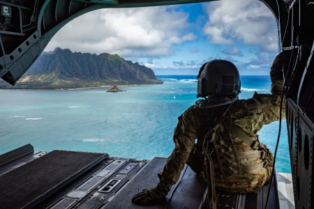 U.S. Army Sgt. Shelby Lewis, a flight engineer assigned to Company B, 2nd Battalion, 211th Aviation Regiment, 103rd Troop Command, Hawaii Army National Guard (HIARNG), conducts flight operations during a CH-47 Chinook flight for Recruit...
