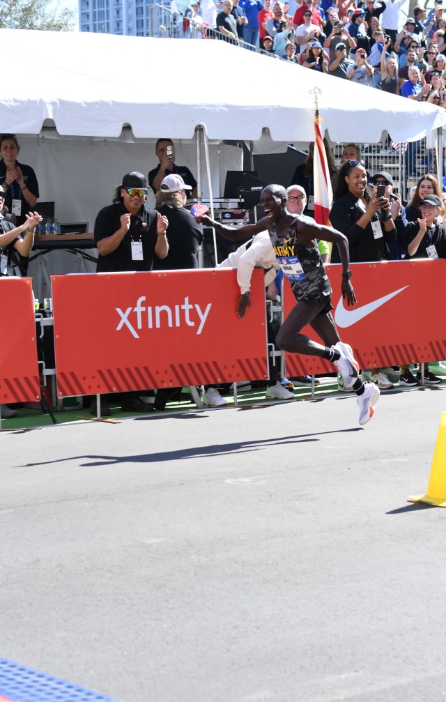 Staff Sgt. Leonard Korir, a Soldier-Athlete with the U.S. Army World Class Athlete Program, exults before crossing the finish line during the U.S. Olympic Marathon Trials on Feb. 3 in Orlando, Florida. Korir won the bronze medal in a time of 2...