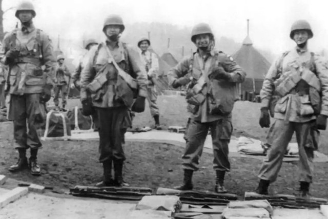 Army Pvt. John Steele, second from right, and three other soldiers pose for a photo during World War II.