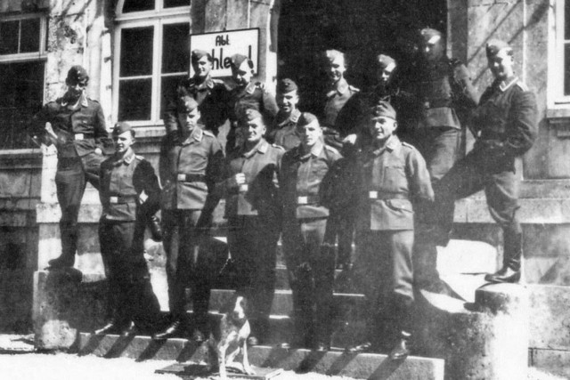 German soldiers pose for a photo in front of the Hotel de Ville in the town of Sainte-Mere-Eglise in Normandy, France, sometime before June 6, 1944, when U.S. Soldiers liberated the town.