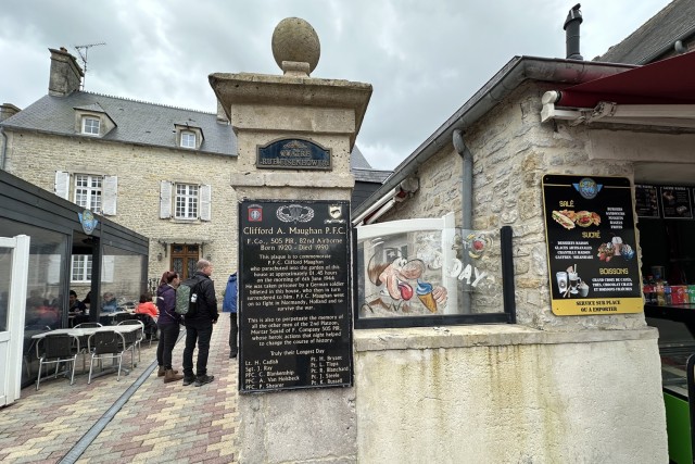 Army Pfc. Clifford A. Maughan parachuted into the garden of this house in the town of Sainte-Mere-Eglise in Normandy, France, on D-Day, June 6, 1944. A plaque honoring Maughan and others is in front of the garden and house, which is now a...