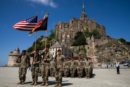 U.S. paratroopers and color guard members assigned to the 82nd Airborne Division prepare for a ceremony outside of Mont-Saint-Michel, France, June 2, 2024, to commemorate the 80th anniversary of D-Day.