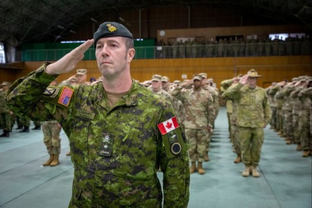 Canadian Army Brig. Gen. Eric Landry, the deputy commanding general - operations of America’s First Corps, along with service members from the U.S. Army, Japan Ground Self-Defense Force, and the Australian Army, render a salute to the national...