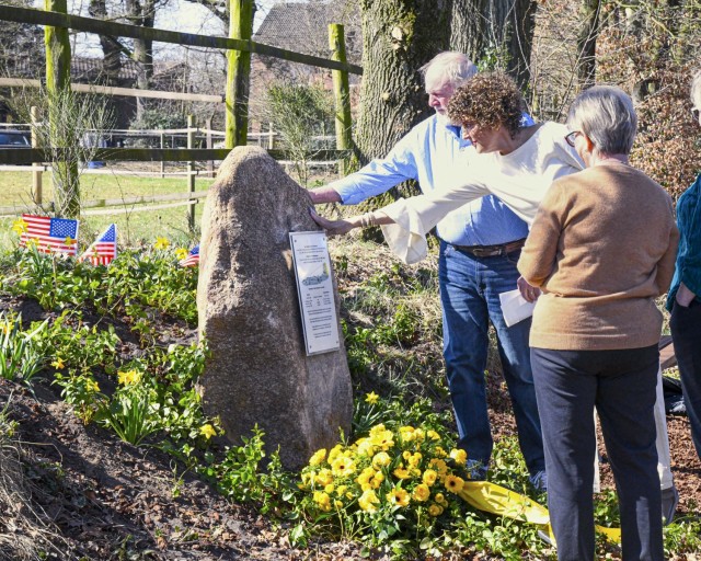 Family members gather around the newly dedicated memorial stone honoring their service members, who were missing in action for nearly 80 years, at a ceremony near Reken, Germany, on March 21, 2025. The U.S. airmen, on mission to bomb Dülmen,...